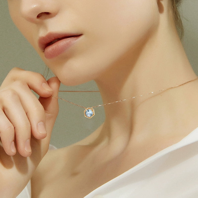Hexagon birthstone necklace worn at the collarbone