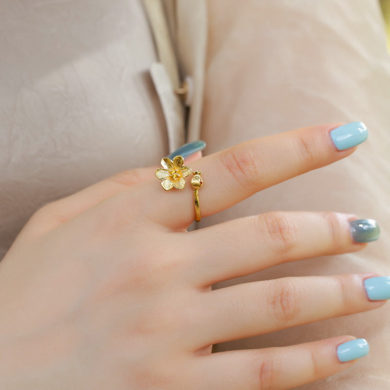 Woman wearing the adjustable pomegranate flower ring