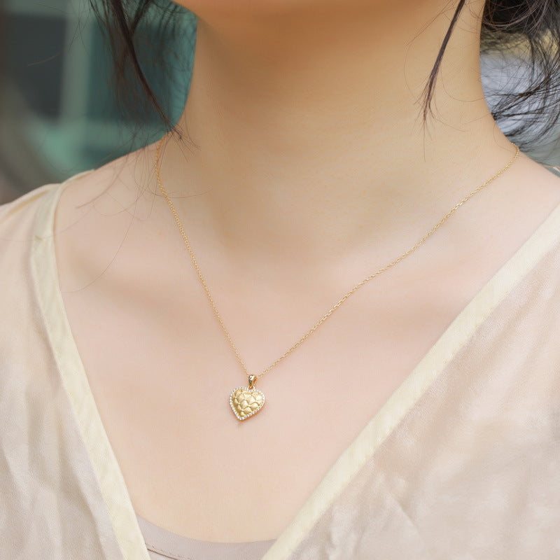 Woman wearing the VYLOREN heart pendant necklace