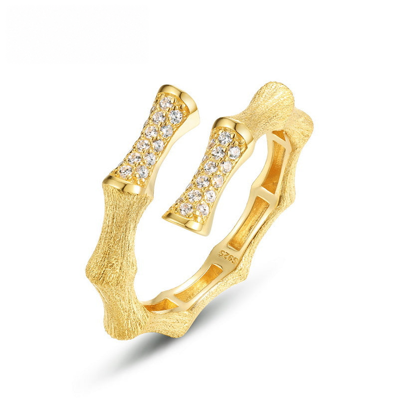 Gold-tone bamboo-inspired open ring with crystal-accented ends