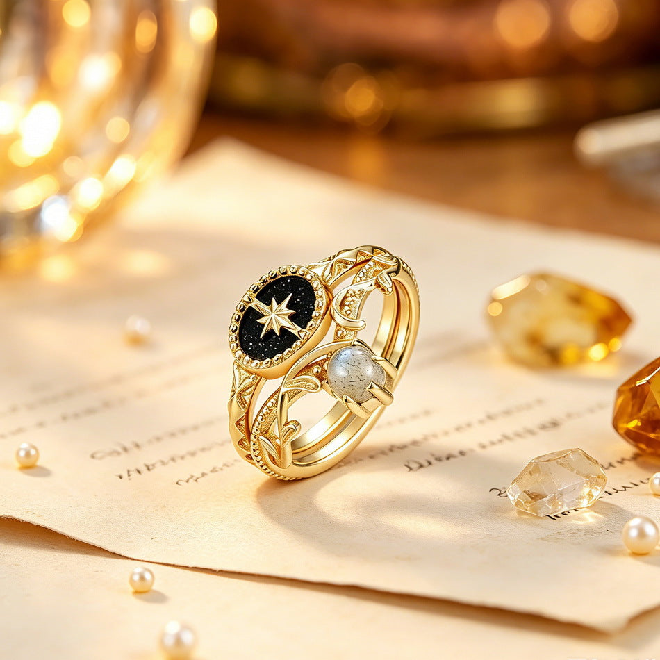 Gold-tone crystal ring with celestial details in a warm tabletop setting